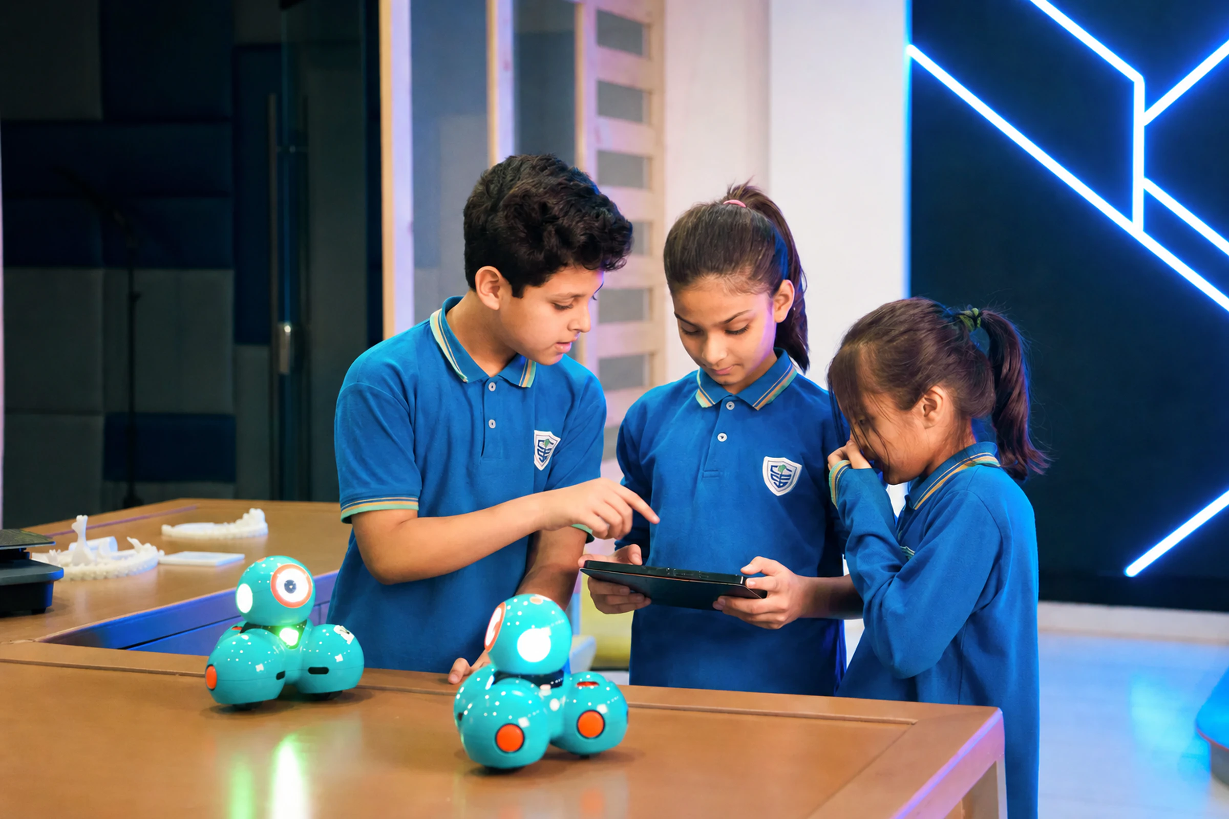 CSI students programming robots in a technology lab.