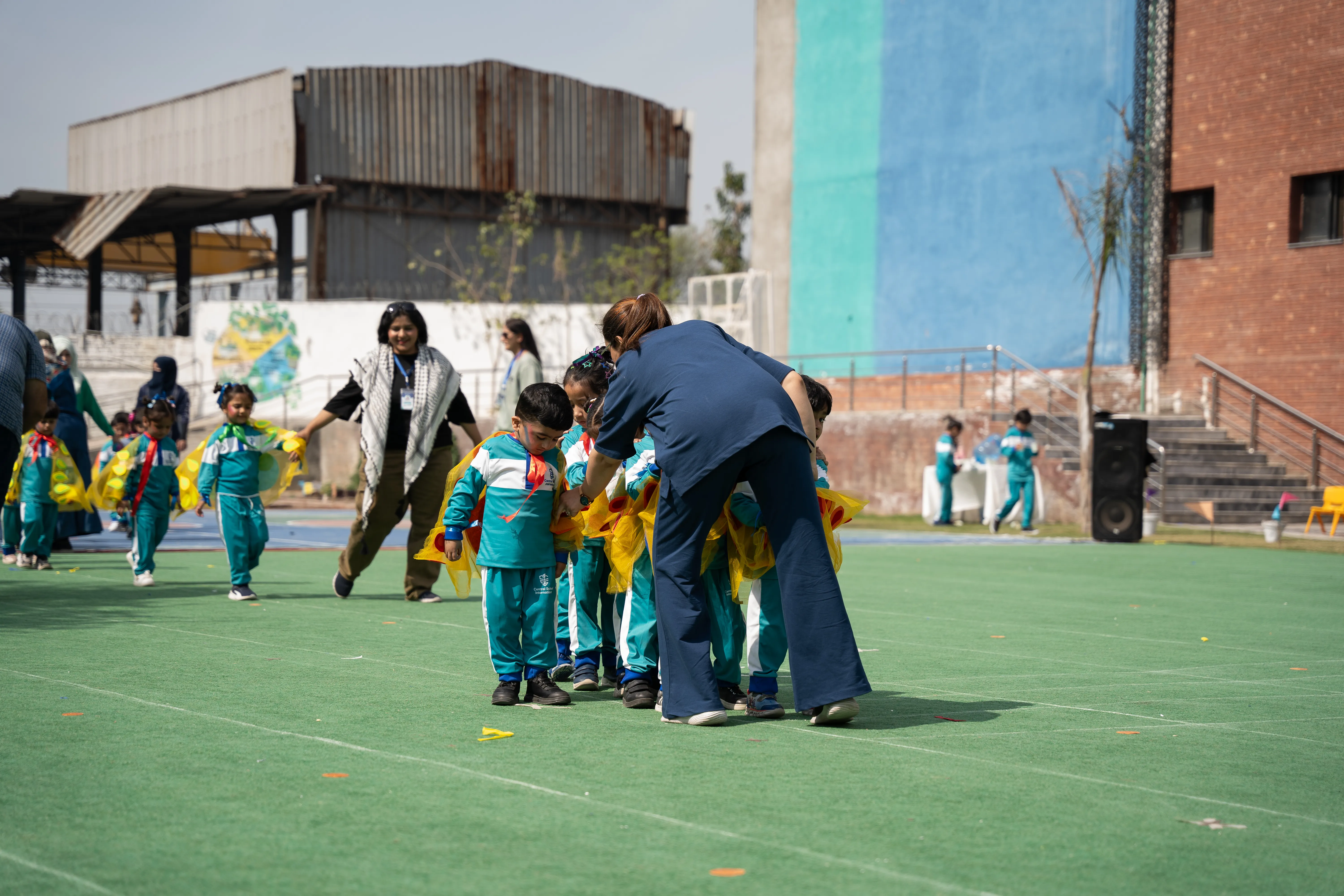 CSI young children preparing for an outdoor movement activity with an adult.